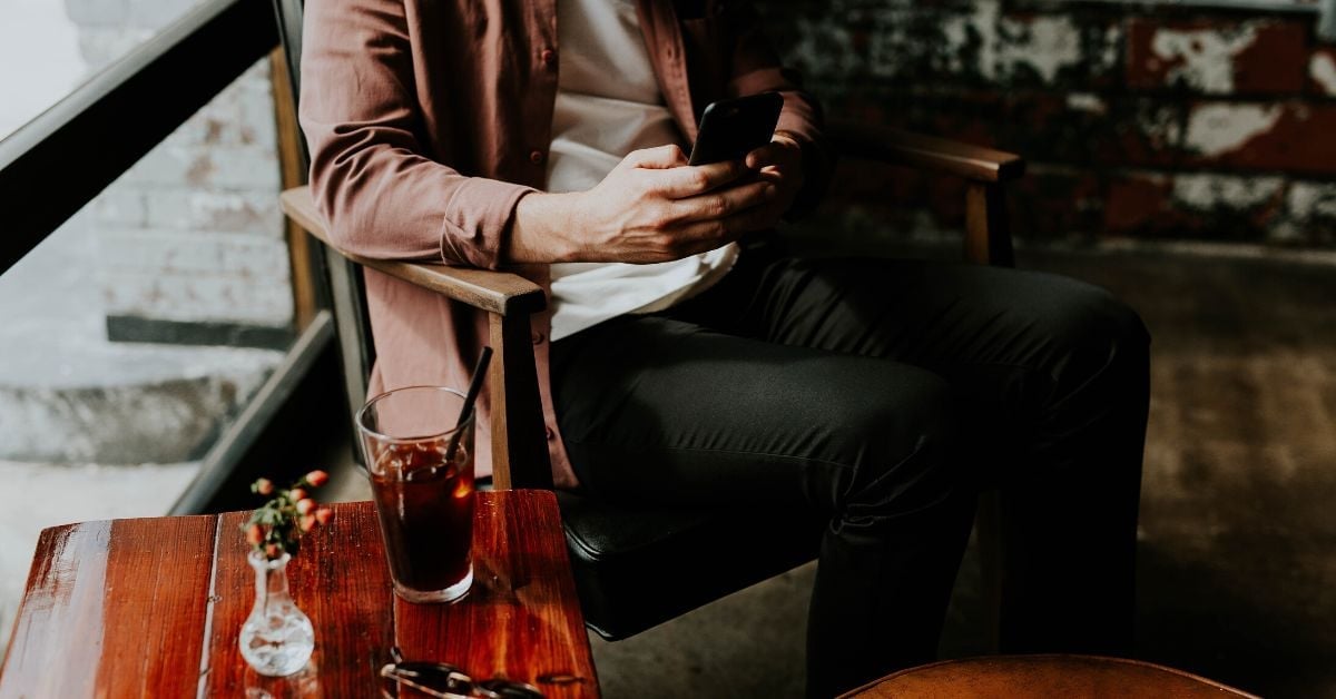 Man in cafe using phone
