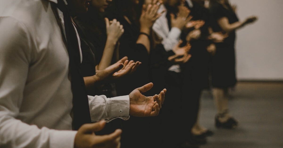 people standing in prayer