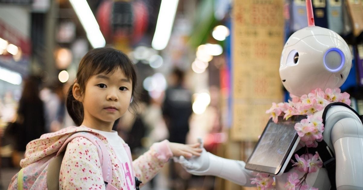 girl holding robot's hand on a street